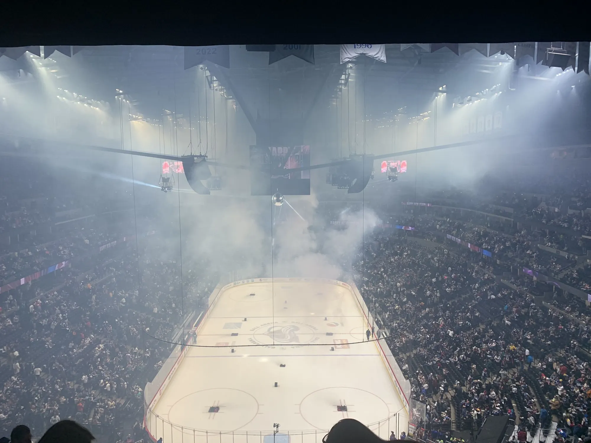 Pregame smoke and lights over the ice at Ball Arena